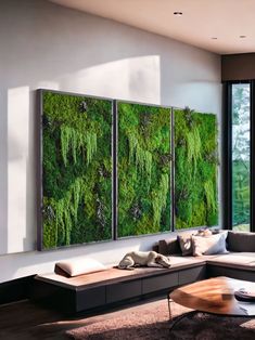 a living room filled with lots of furniture and green wall art hanging on the walls