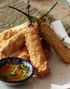 fried food on a plate with dipping sauce