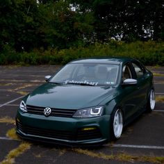 a green car parked in a parking lot