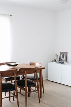 a dining room table with four chairs around it