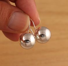 This is solid 925 Sterling Silver plain ball earrings. Approx. measures:         drop/length : 26mm         ball diameter: 14mm  Approx. weight: 6.6gr. Presented in gift box!     Thank you for looking! Silver Spherical Earrings As Gift, Sterling Silver Sphere Earrings For Gift, Ball Earrings, Earring Gifts, Solid 925 Sterling Silver, Jewelry Earrings Dangle, Etsy Earrings, Dangle Drop Earrings, Dangle Earrings