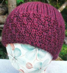 a close up of a knitted hat on a mannequin head