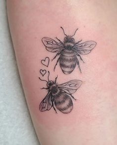 two bees with hearts on their legs