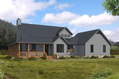 a large gray house sitting on top of a lush green field next to a forest