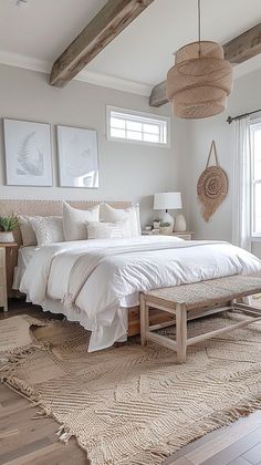 a bedroom with white bedding and natural wood beams in the ceiling, along with wicker furniture