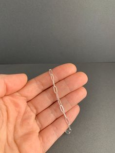 This is a medium strong solid silver chain I will cut to length for you, and add a lobster clasp. *Please allow a week for me to create your chain. I usually have many feet on hand, but in the event that several long chains are ordered I may need to restock my supply to fill your order* It is appropriate for a small to large pendant, nothing extremely heavy. This is a shiny silver chain with flat elongated links that measure 3.2mm wide and 8mm long. You can purchase this chain along with one of Locket Design, Kurti Design, A Necklace, Hand Jewelry, Girly Jewelry, Long Chain, Shiny Silver, Delicate Bracelet, Chain Lengths