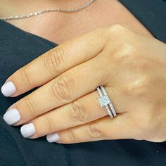 a woman's hand with a diamond ring on it