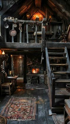 an old fashioned wooden cabin with stairs leading up to the second floor and another room on the other side