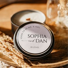 personalized soy candle tins on a wooden tray