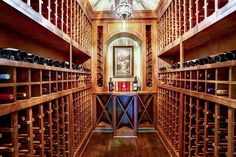 a wine cellar with wooden shelves filled with bottles