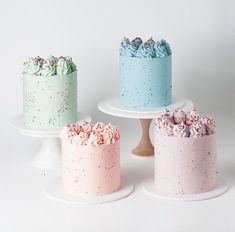 three cakes with sprinkles on them sitting on top of each other