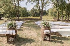 an outdoor ceremony set up with white linen draped over the tables and chairs in front of trees