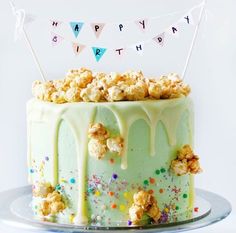 a birthday cake decorated with popcorn and streamers