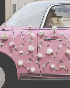 a pink car with white flowers on it