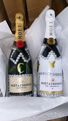 two bottles of champagne are sitting in a box