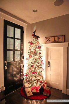 a decorated christmas tree in the corner of a room