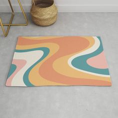 a rug with an abstract design on the floor next to a basket and planter