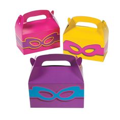 three different colored boxes with masks on the top one is pink, yellow and purple