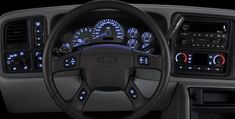 the interior of a vehicle with various gauges and dash lights, including steering wheel