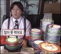 a man sitting at a table filled with plates