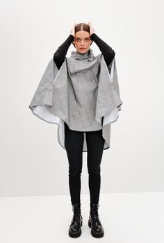 Pluvo's Rain Capes are functional and a unisex design with an elegant fit, they are perfect for every day, going around town, camping, going to concerts or riding your bike. Rain Capes are made from a waterproof lightweight fabric, they will save you from the rain and bring you home safe and sound. When riding your bike, you can adjust your cape with its front rubber bands and, if you're walking, you can keep your cape from flying away by using the ones on the zippers. DETAILS: - Adjustable hood that can be stored in pocket - Inner pocket - Front zipper - Reflective on neck and logo - Grip rubbers for riding bike - Includes small storage bag - 100% polyester TECHNOLOGY:  - Waterproof technologies Laftech: Laftech is the technological seal of Lafayette Sports developed by scientists who see Cape In Wind, Cycling Poncho, Techwear Poncho, Oversized Hooded Outdoor Cape, Oversized Gray Cape Outerwear, Gray Oversized Cape Outerwear, Poncho Raincoat, Cape Fashion, Rain Cape