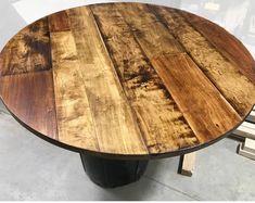 a round wooden table sitting on top of a floor