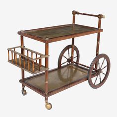 an antique wooden cart with wheels and bars on the bottom shelf is shown in front of a white background