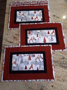 three red and black placemats sitting on top of a counter