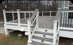 a white deck with stairs and railings