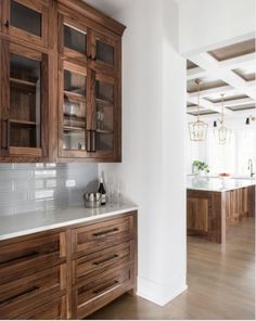 a kitchen with wooden cabinets and white counter tops