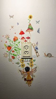 an electrical outlet on the wall with flowers and butterflies around it