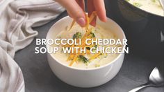 broccoli cheddar soup with chicken is being served in a white bowl