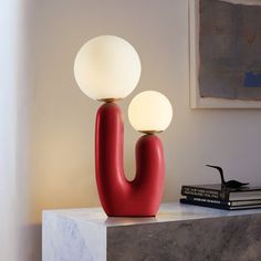 This table lamp is made of a milk-white glass ball and a high-quality dome base. This artistically designed table lamp adds a stylish modern Nordic style to your space. Whether it is placed on the bedside table, the side table of the study, or your favorite reading corner, this set of lights is suitable for this space and adds a full artistic atmosphere to the space. Wade Logan® Base Color: Red Wade Logan® Rahil Two Glass Ball Bedside Table Lamp in Red | Size 19.29" H X 9.84" W X 7.08" D | AllMo Red Base Lamps, Nursery Light Fixture, Nursery Ceiling, Dandelion Light, Kids Ceiling Lights, Lamp Nursery, Nordic Table, Red Table Lamp, Kids Room Lighting