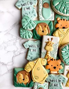 some cookies are decorated with different animals and words on them, including one that says wild one