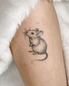 a small mouse tattoo on the right leg, it looks like someone has been inked