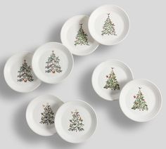 six white plates with christmas trees on them