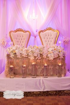 the chairs are covered with flowers and candles