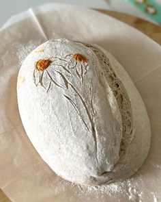 a piece of bread sitting on top of a white paper towel covered in powdered sugar