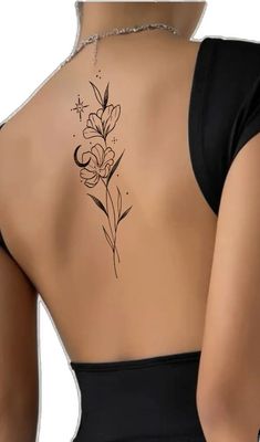 a woman's back tattoo with flowers on it