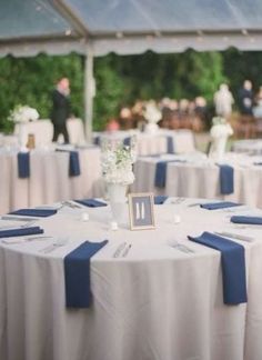 the tables are covered with white and blue linens