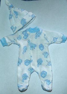 a baby's blue and white outfit laying on top of a box