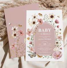 two pink and gold floral baby shower cards on top of a furnishing area