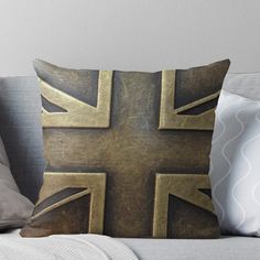 a gold union jack throw pillow on a couch