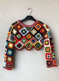 a colorful sweater hanging on a wall