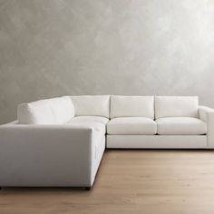 a white couch sitting on top of a hard wood floor