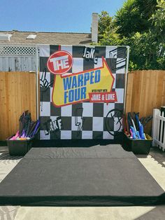 an outdoor stage set up for a competition with various items on it and the words warped four written in large letters