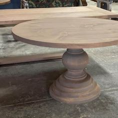 a wooden table sitting on top of a cement floor