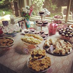 a table filled with lots of desserts and pastries