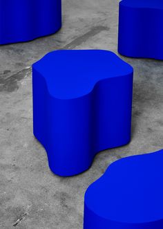 several blue circular tables sitting on cement ground