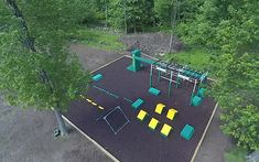 an aerial view of a playground in the woods